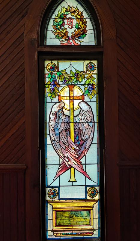 Armstrong Memorial Window:  haloed cross, enveloped by two wings