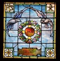 Satterlee Memorial Window:  two doves hovering above a flowering wreath with a Byzantine cross