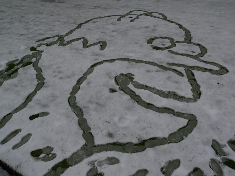 Homer Simpson marked out in snow, King's Parade, Cambridge, England