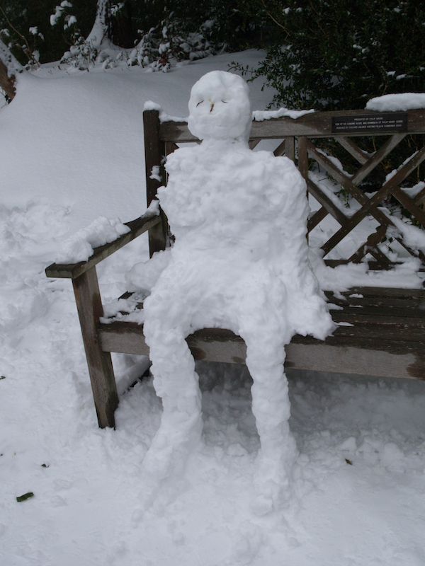 snow man sitting on bench, Fellows' Garden, Trinity College, Cambridge, England