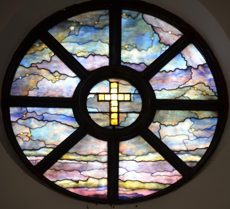 rose window with gold glass jeweled cross
