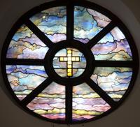 rose window with gold glass jeweled cross