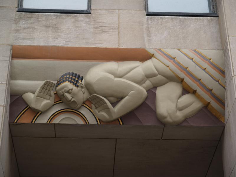 New York City, NY: 30 Rockefeller Plaza (GE Building, formerly RCA Building, Rockefeller Center): 'Sound' (decoration above left door) (art deco, 1932, Lee Lawrie, colorist Leon V. Solon)