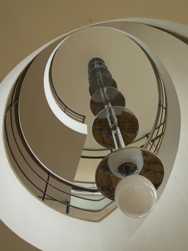 Bexhill-on-Sea, England: De La Warr Pavilion: spiral staircase and chandelier from below (1935, Erich Mendelsohn and Serge Chermayeff; restored 2005, John McAslan and Partners)