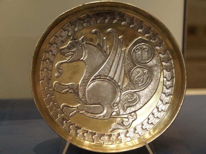 London, England: British Museum: gilded silver plate with senmurw (head of snarling dog, paws of lion, tail of peacock) (about 7th-9th century AD, possibly from India)