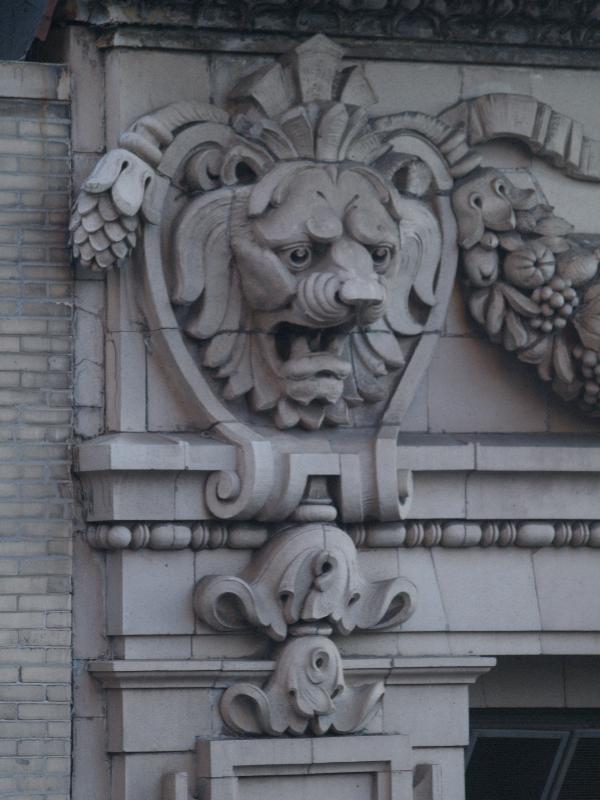New York City, NY: 320 Fifth Avenue (32nd Street side): lion decoration at top of building