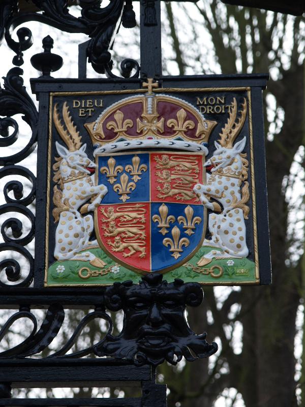 Cambridge, England: King's College: shield on Queen's Road gate