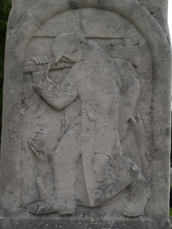 Trumpington, England: War Memorial: relief of (Great War) soldier (1921-1922, Eric Gill)