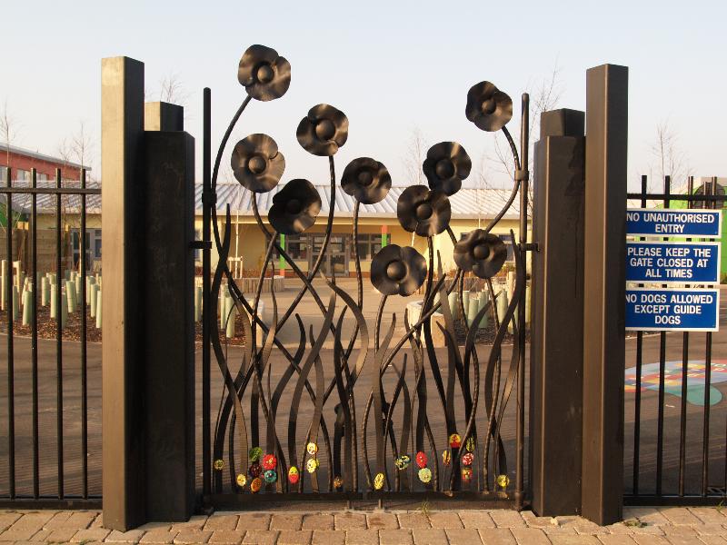Cambridge, England: Orchard Park Community Primary School: decorative gate (2007-2008, artist Adam Booth, Pipers Forge; architect Mouchel Group)
