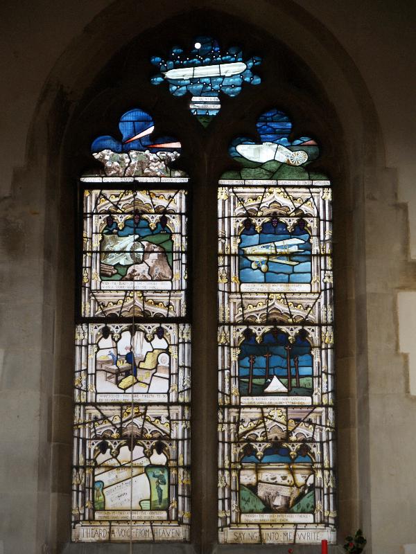 Swaffham Prior, England: St Mary's Church: Great War (World War I) left memorial window (scenes from bottom left: call to war; shell factory; howitzer; liquid fire; zeppelin; tank; German aeroplane; field telegraph tent; captured dug-out) (1919, designed by T F Curtis, made by Ward and Hughes)