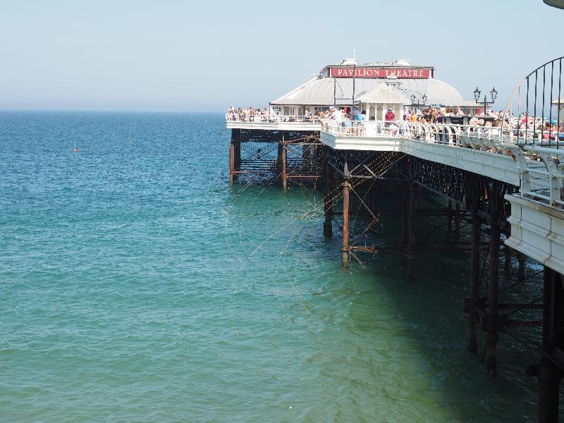 Cromer, England: pier: people fishing for crabs
