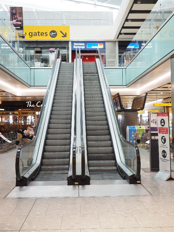 London, England: Heathrow Airport, Terminal 5: quiet escalator (because of Covid-19)