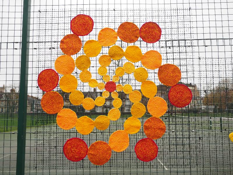 Cambridge, England: Jesus Green: spiral of sunny disks (displayed Dec 2020 / Jan 2021, Cambridge Yarn Collective)