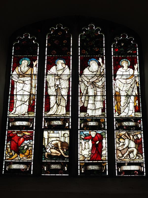 Cambridge, England: Jesus College: chapel, nave, north wall, west window (Isaiah / Jeremiah / Ezekiel / Daniel // Death of Sennacherib / Nebachudnezzer / Elijah / Daniel in the Lions' Den, 1877-1878, Morris & Co)