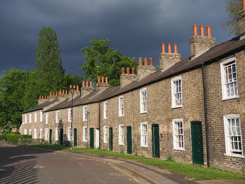 Cambridge, England: Lower Park Street: houses in sun with dark clouds